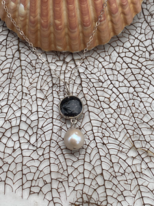 Bermuda black volcanic sand silver medium round bezel and white pearl necklace